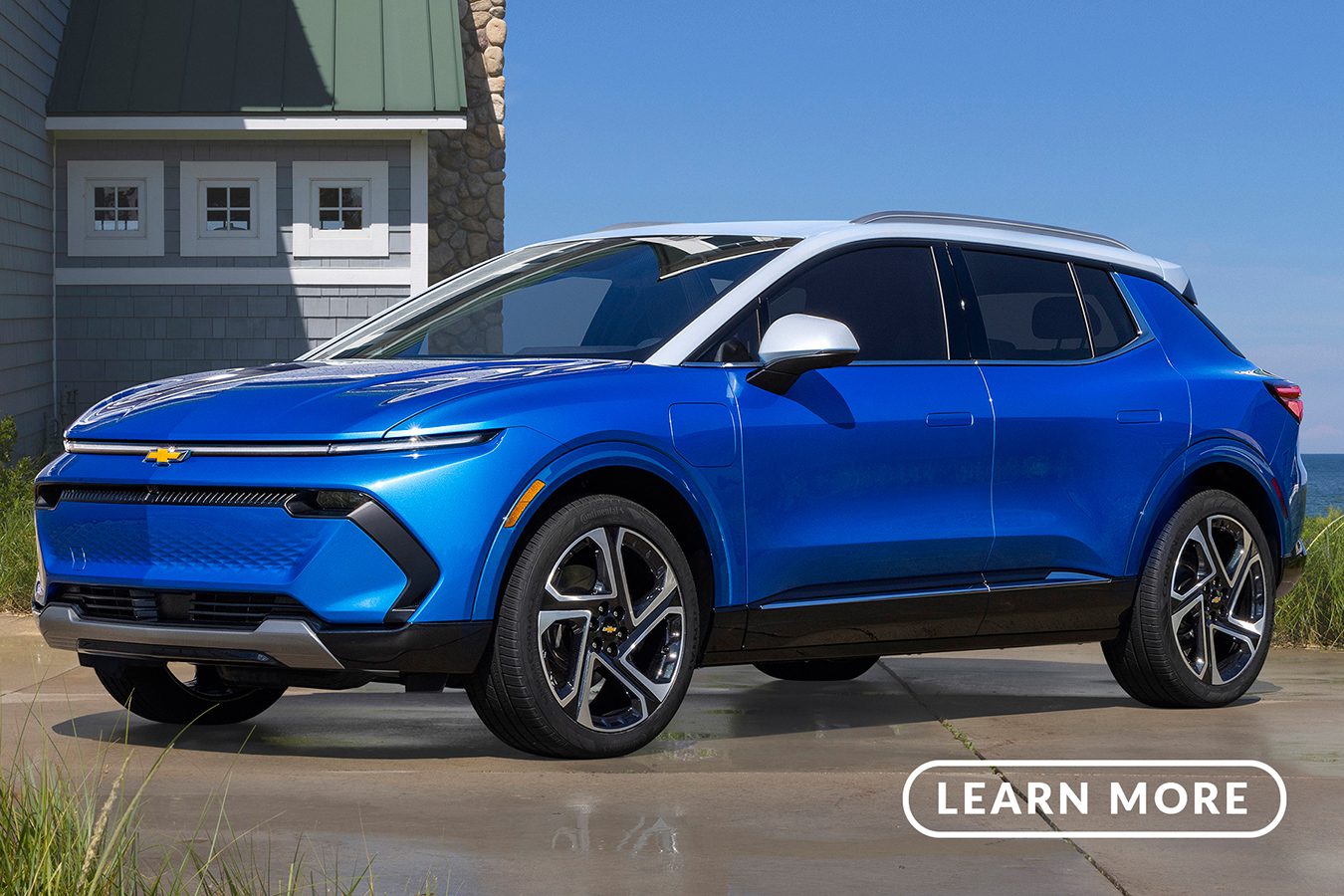 The 2020 chevrolet volt is parked in front of a beach.