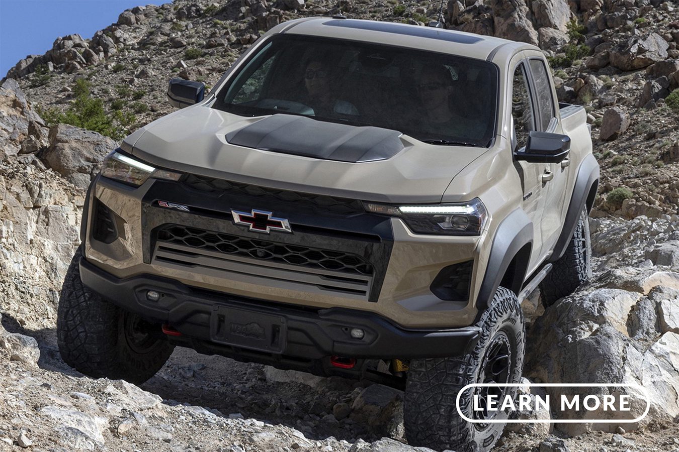 The 2020 chevrolet colorado is driving down a rocky trail.