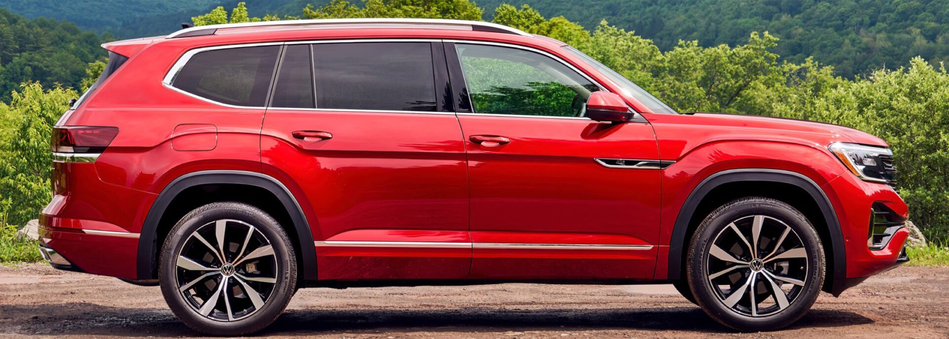 The red 2019 volkswagen atlas is parked on a dirt road.