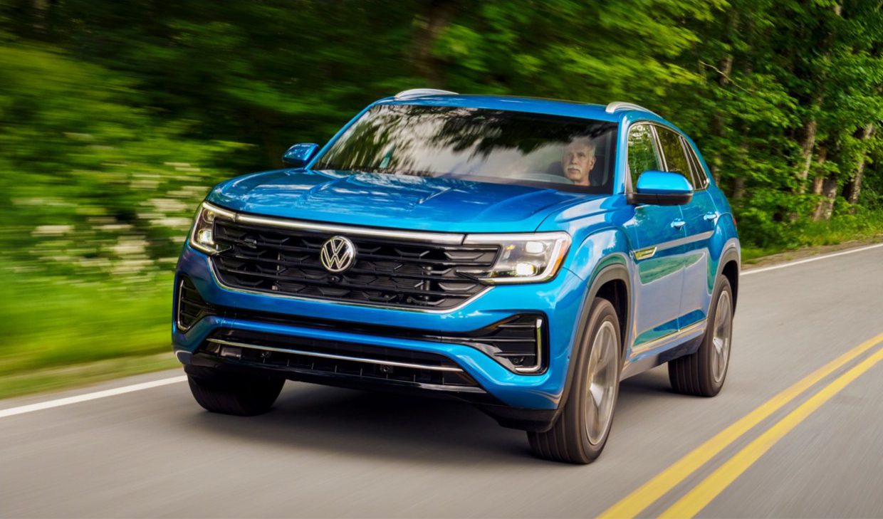 The 2020 volkswagen atlas is driving down a country road.