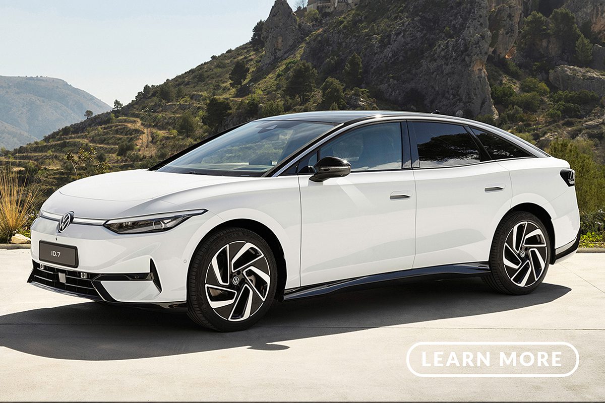 A white chevrolet ion parked in front of a mountain.