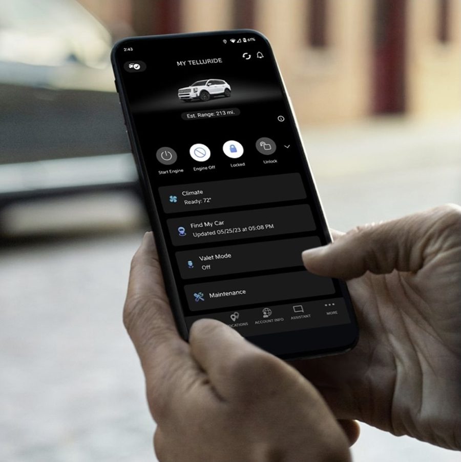 A person holding a smartphone with a car app on it.