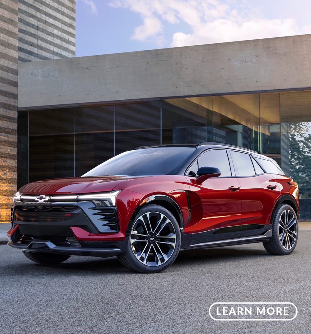 The 2020 chevrolet volt is parked in front of a building.